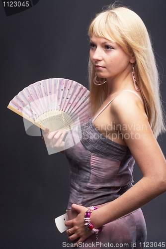 Image of Beautiful young woman with fan
