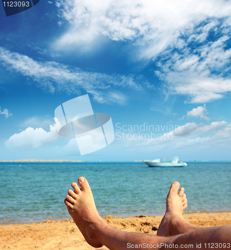 Image of man foots on beach