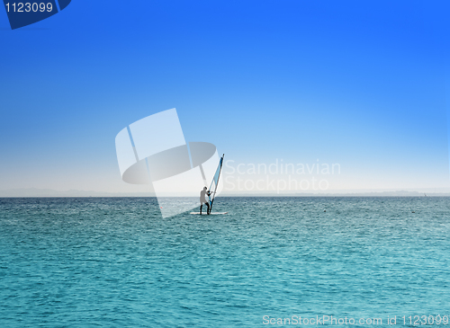 Image of surfer on blue sea under sky