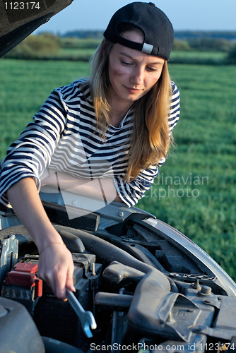 Image of Young Blond Woman With Her Broken Car