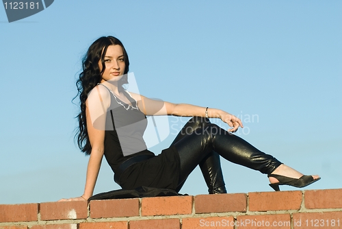 Image of Sitting girl on roof