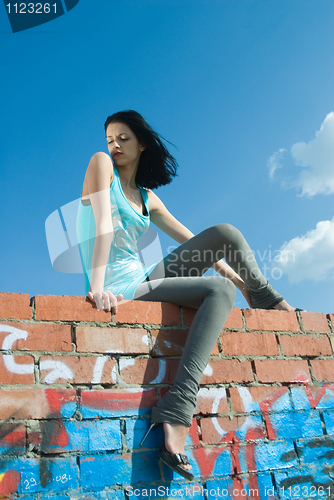 Image of Young woman on roof