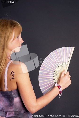 Image of Beautiful young woman with fan