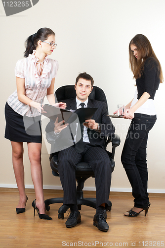 Image of Businessman with assistants