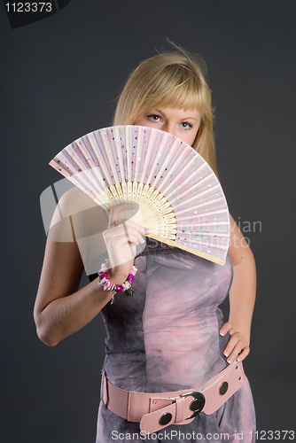 Image of Beautiful young woman with fan