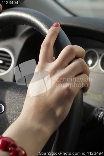 Image of Girl hand on wheel steering