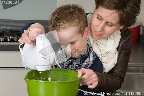 Image of Mother and son mixing the dough