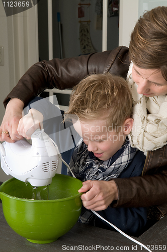 Image of Mother and son mixing the dough