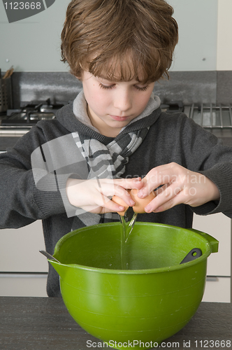 Image of Boy making the dough for the cakes