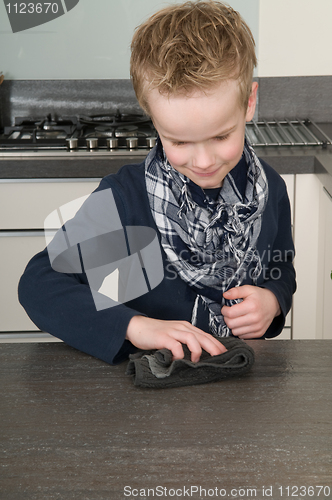 Image of Boy cleaning the kitchen