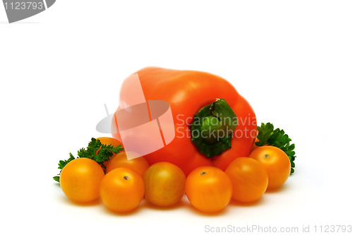 Image of fresh yellow tomatoes with paprika and parsley