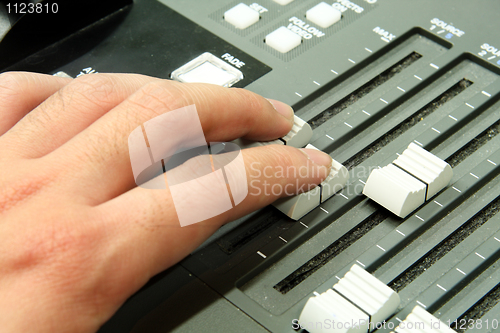 Image of Closeup of audio mixing console. Shallow depth of field. Studio 