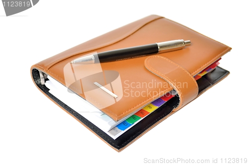 Image of Daily planner with pen on a white background