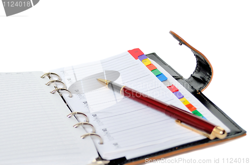 Image of Daily planner with pen isolated on white background