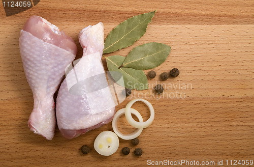 Image of raw chicken meat with herbs, onions and peppers