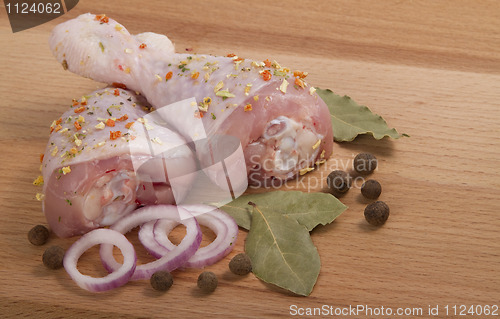 Image of raw chicken meat with herbs, onions and peppers