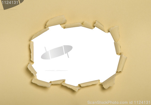 Image of a hole punched into cream paper