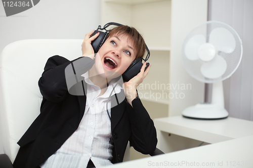 Image of Emotional woman listening to music with big headphones