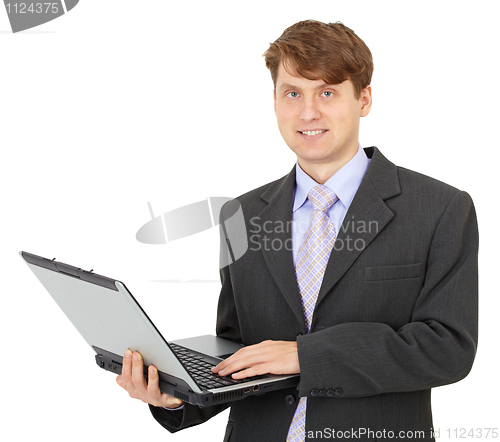 Image of Young businessman with computer in hands