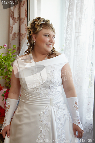 Image of Bride at window waiting for groom