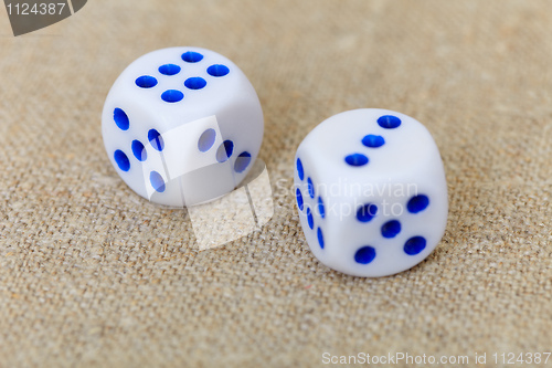 Image of Two dice on coarse linen