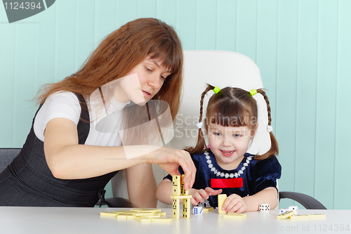 Image of Mother and daughter play at table