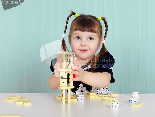 Image of Child playing with small toys at table