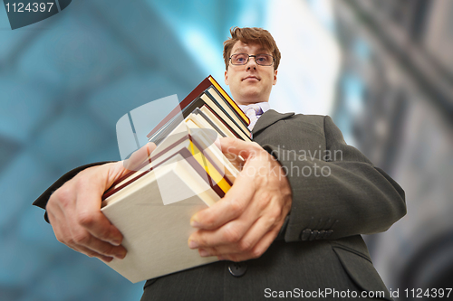 Image of Librarian holding pile of books