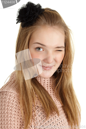 Image of Playful young girl winks on white background