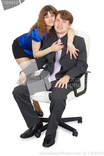 Image of Woman embraces a young man in an office chair