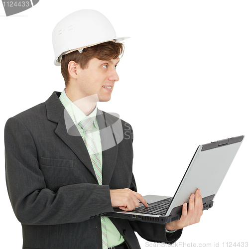 Image of Smiling engineer in helmet with laptop in hands