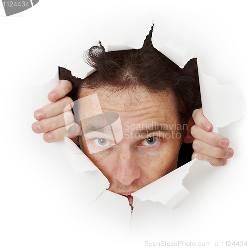 Image of Man breaks out of hole in paper