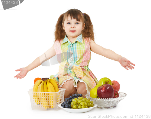 Image of Little girl with big heap of different fruits