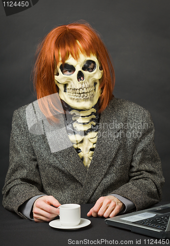 Image of Horrible man - skeleton with red hair drinking coffee