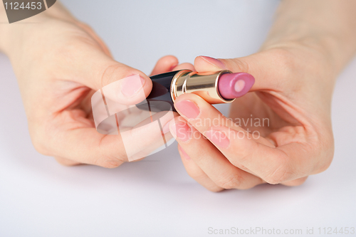 Image of Red lipstick in hands