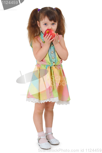 Image of Sad little girl to eat apple on white background