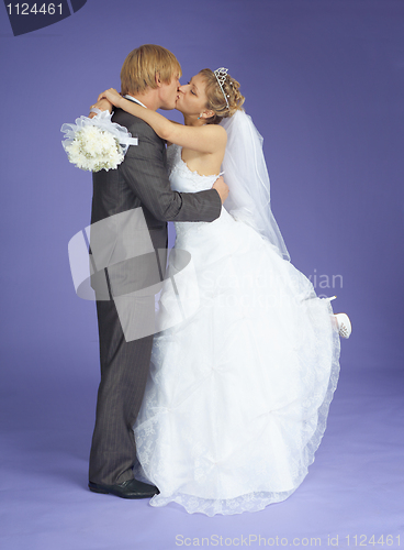 Image of Newly-married couple kisses