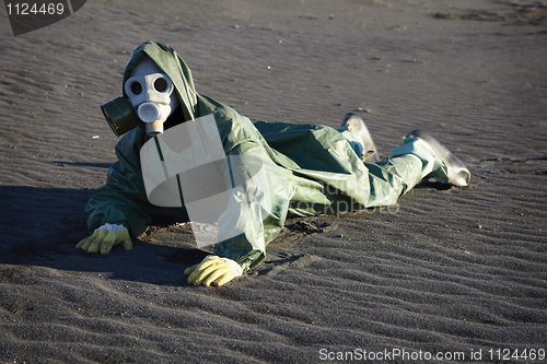 Image of Man in gas-mask on desert ground