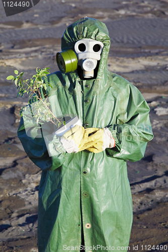 Image of Scientific Environmentalist gently hugs a plant