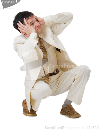 Image of Frightened young man sits on white