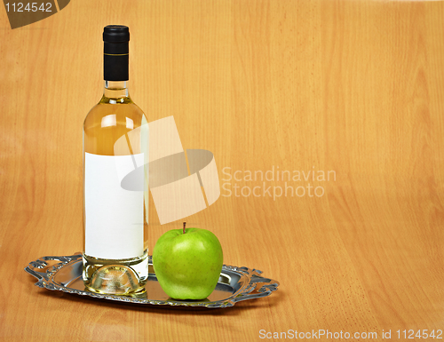 Image of Still-life - bottle of white wine and green apple