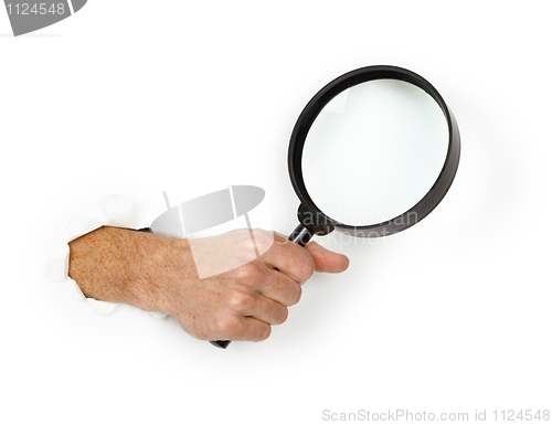 Image of Hand holding magnifying glass on white