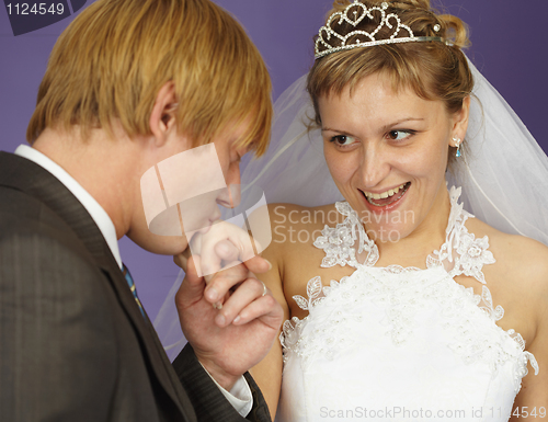 Image of Gallant groom kisses hand