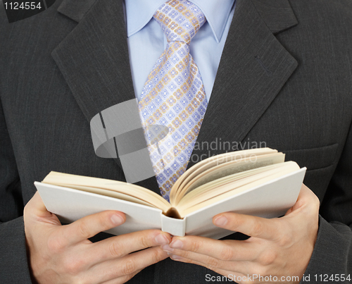 Image of Businessman reading statute book