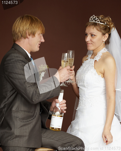 Image of Newlywed drinking champagne clinking glasses