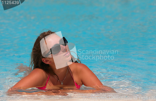 Image of attractive young woman at a pool 