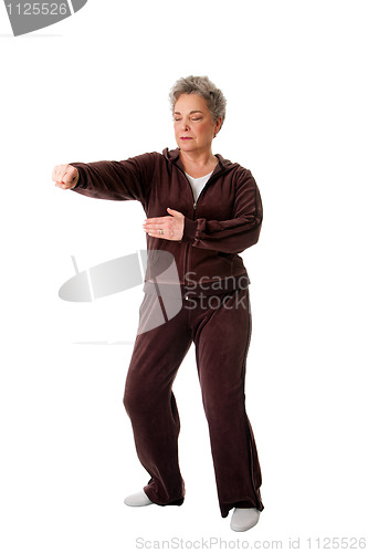 Image of Senior woman doing Tai Chi Yoga exercise