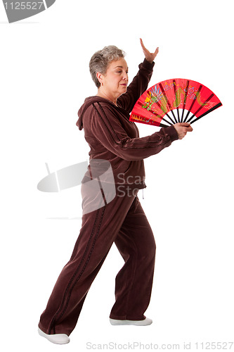 Image of Senior woman doing Tai Chi Yoga exercise