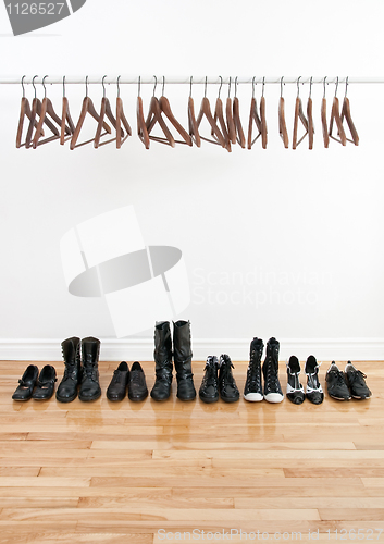 Image of Row of shoes and empty hangers