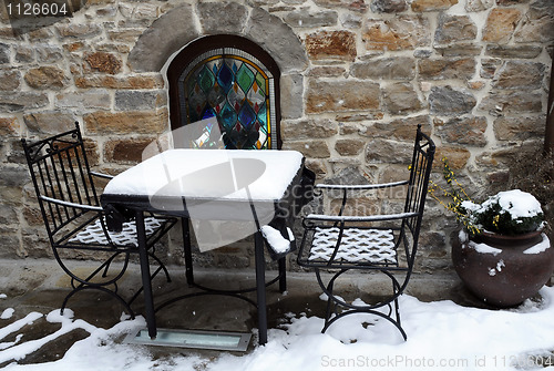 Image of Table and Chairs Covered With Snow